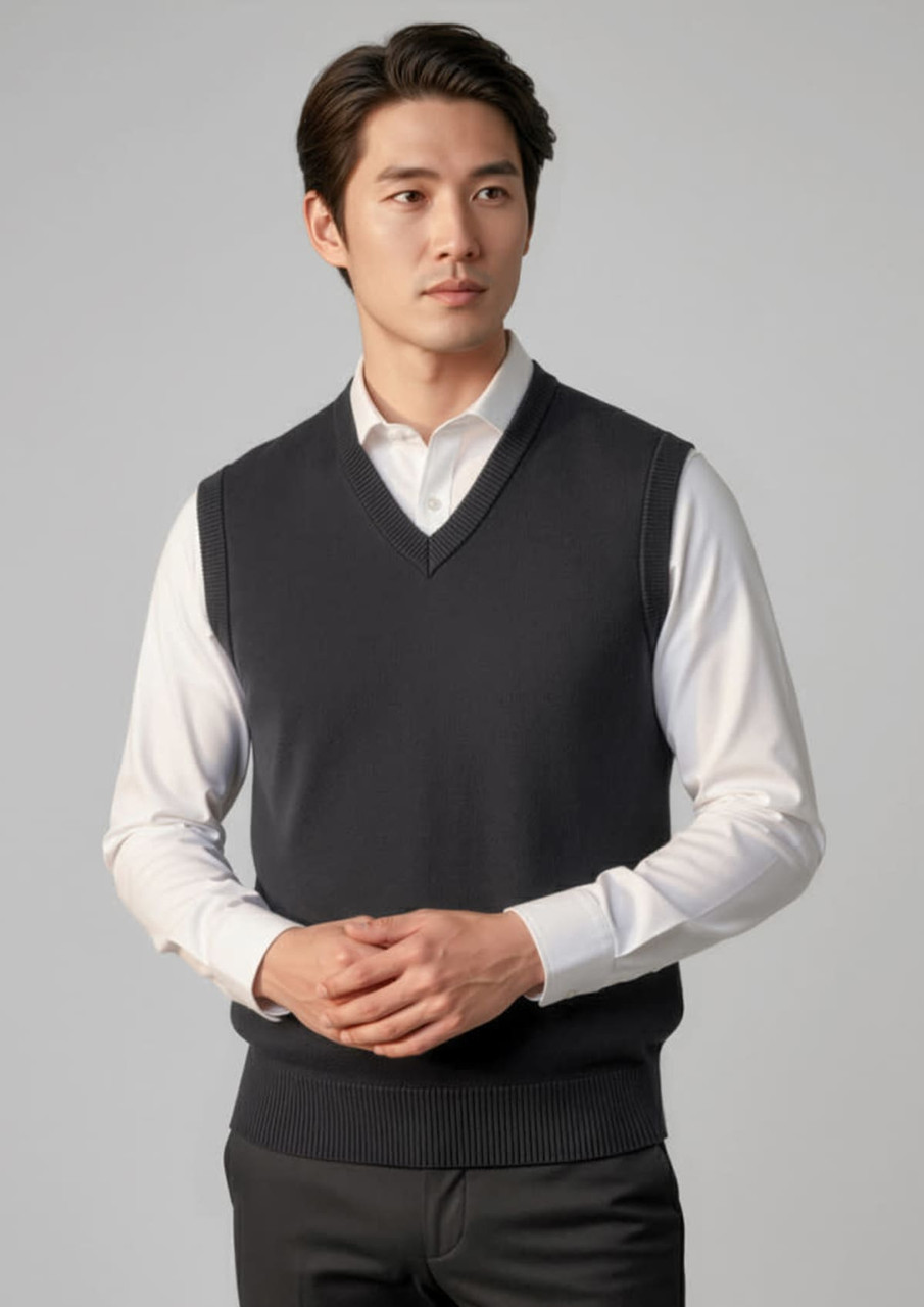 A dark grey woolmix knit vest is displayed on a model, featuring a v-neck and ribbed hem.