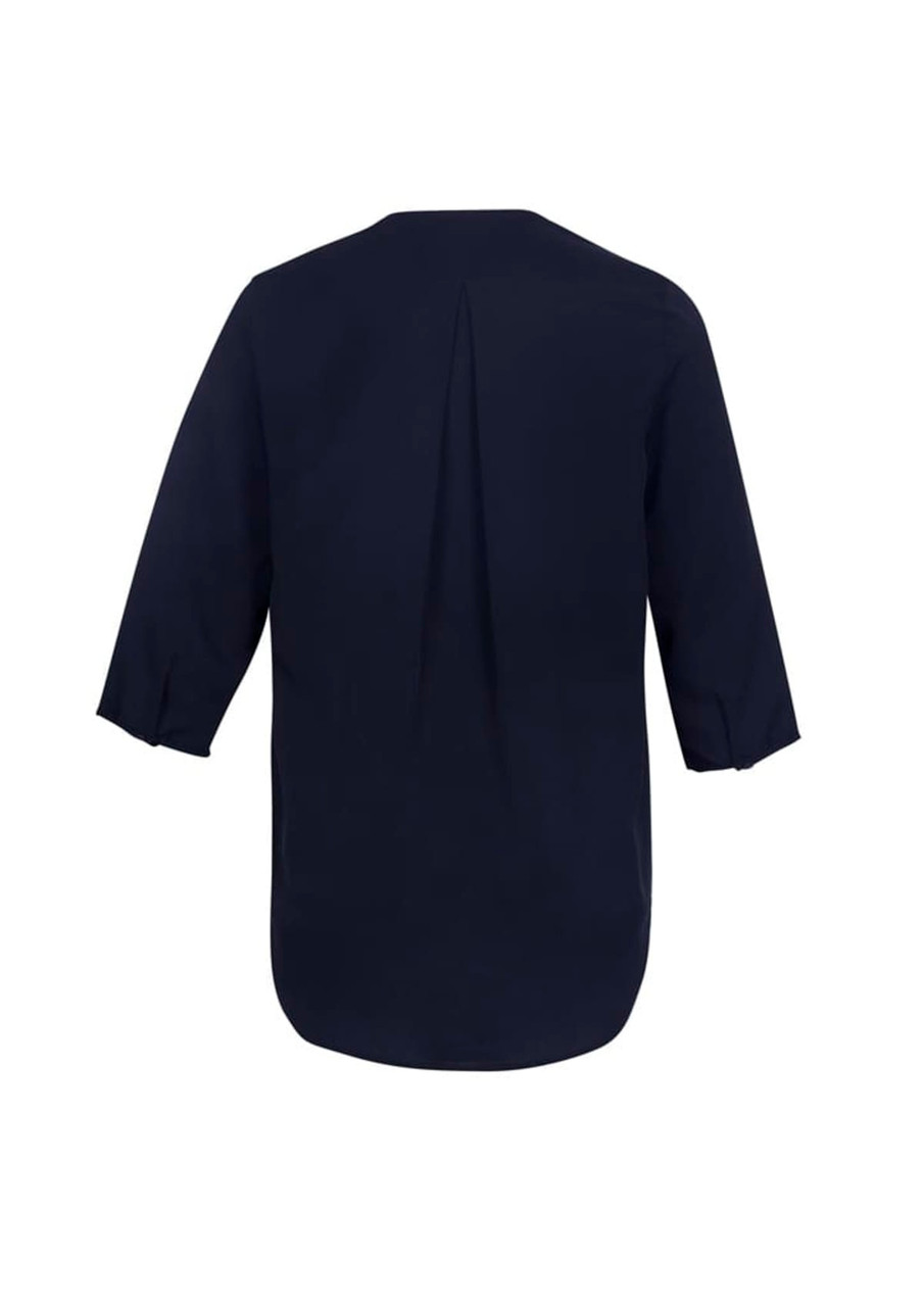 A women's longline blouse in navy blue with three-quarter sleeves and a back pleat, featuring a branded logo.