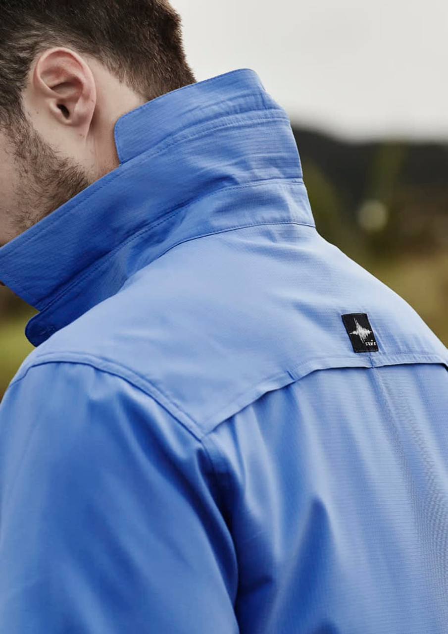 A men's short sleeve button-up shirt in blue, featuring a collar and a logo on the back.