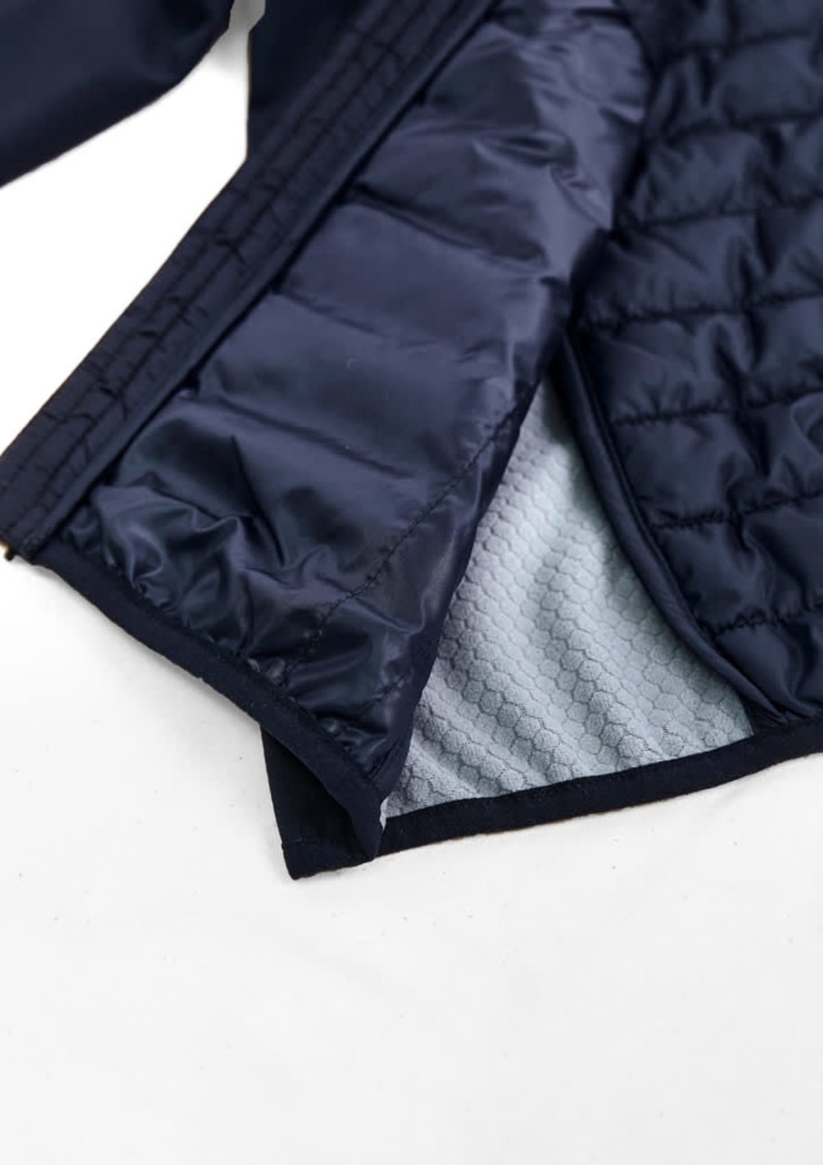 A unisex patrol jacket in navy blue, featuring a quilted lining and an interior texture pattern. It includes a logo.