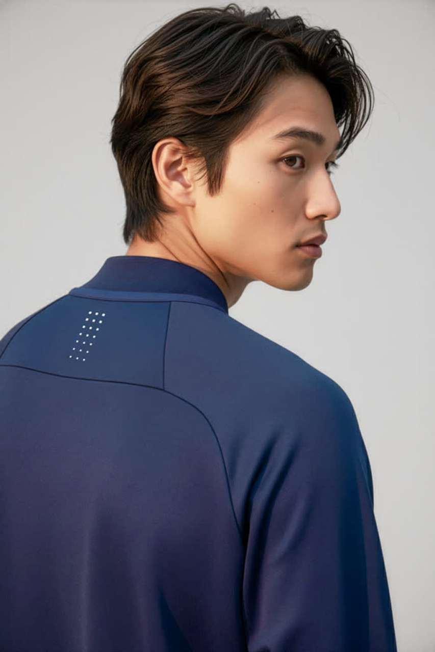 A navy unisex mid layer top with a simple design and a logo on the back collar.