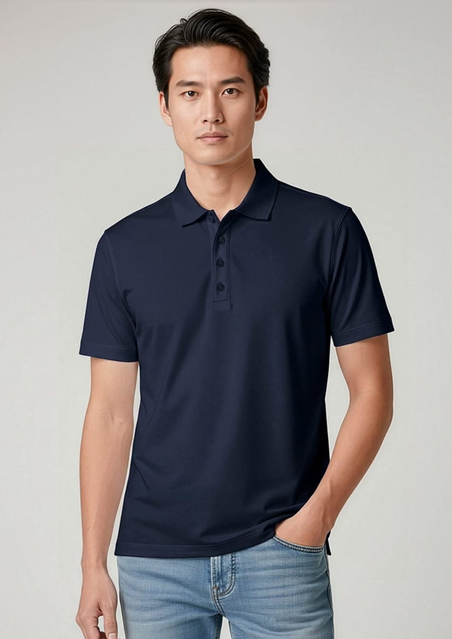 A navy short sleeve polo shirt featuring a collar and a branded logo. Model wears it with light blue jeans.