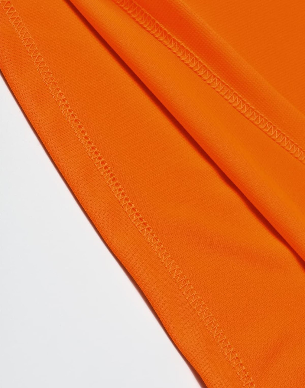An orange AIWX Vented Cooldry Polo with visible stitching details, featuring a branding logo.