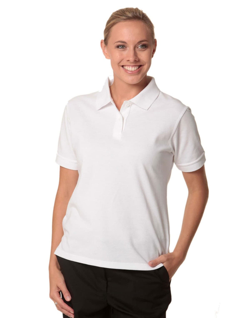 A woman wearing a white polo shirt with a collar, featuring a logo on the chest.