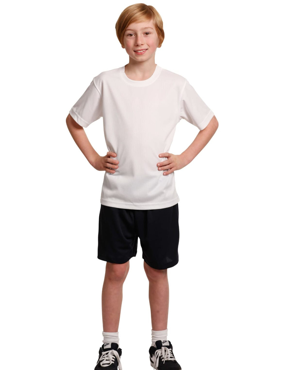 Kids cooldry sports shorts in black, paired with a white sports t-shirt. The outfit is modelled by a young boy.
