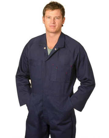 A man wearing a navy blue cotton drill coverall with multiple pockets and a logo.