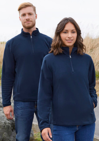 A navy fleece jacket featuring a half-zip design, displayed on both male and female models in an outdoor setting.