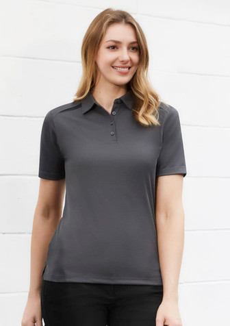 A women's short sleeve polo shirt in dark grey, featuring a collar and a front button placket. It has a logo on the chest.