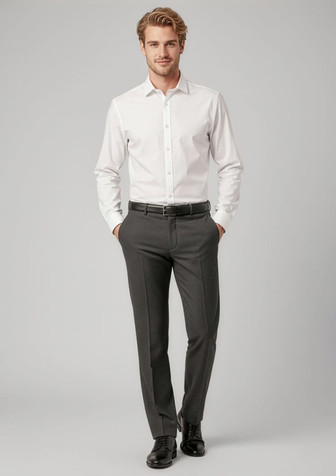 A man stands wearing a white shirt and grey classic flat pants, paired with a belt and black shoes. The outfit includes branding.