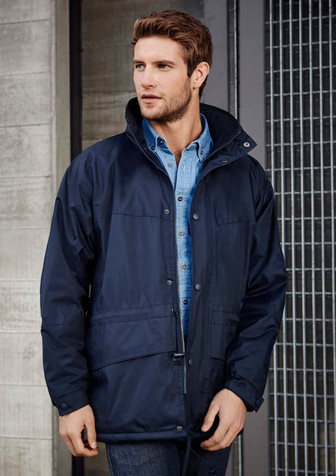 A navy unisex Trekka jacket is worn by a man, featuring a zip and snap closures, with a branded logo.