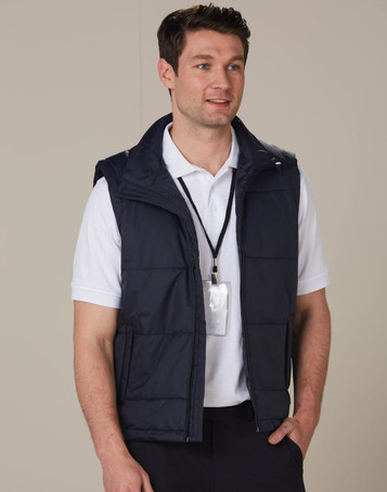 A man wearing a navy blue padded nylon rip-stop vest over a white polo shirt, with a lanyard around his neck.