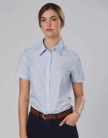 A light blue women's button-up shirt with short sleeves, featuring a collar and a logo.