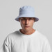 A light blue nylon bucket hat with a wide brim and a logo, worn by a model against a plain background.