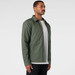 A green service jacket with a collar, featuring a side pocket and a minimalist design.