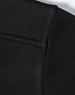 A close-up of a black men's jacquard fleece jacket, featuring textured fabric and a smooth collar.