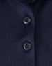 Close-up of a navy blue polo shirt featuring a button placket and a logo.