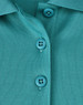 A close-up of a teal poly/cotton polo shirt featuring two buttons and a collar.