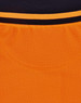 A close-up view of a unisex hi-vis polo shirt featuring orange and black colours, with a ribbed texture and a logo.