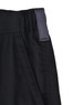 Close-up of black unisex utility stretch cargo work shorts featuring a wide waistband and a tag.