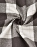 A close-up of grey and white flannel fabric with a plaid pattern, showing the texture and weave.