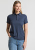 A women's short sleeve polo shirt in navy blue, featuring a collar and a logo. Model stands with one hand in pocket.