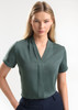A short-sleeve button-up shirt in a soft green colour, featuring a v-neck design and a subtle front pleat.