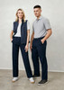 A woman in navy pants and a grey vest stands beside a man in grey polo and navy pants, both with shoes.