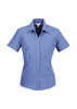 A blue women's short sleeve button-up shirt with a pointed collar and a fitted silhouette, featuring a logo.