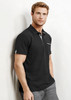 A black short sleeve polo shirt for men featuring a front pocket and a logo. Model wearing grey trousers.