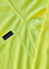 A close-up of a men's long sleeve polo in bright yellow, featuring a logo on the fabric.