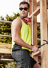 A man wearing a bright yellow hi-vis singlet and sunglasses, holding a hammer, with a construction backdrop.