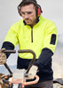 A unisex hi-vis yellow and navy 1/2 zip pullover, featuring a logo and worn by a person operating machinery.