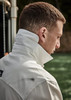 A long sleeve button-up shirt in white, featuring a high collar and casual fit. Includes a logo on the chest.