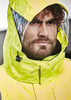 A waterproof jacket in bright yellow with an adjustable hood and clear panel, featuring a rugged design.