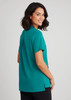 A woman wearing a teal plain tunic, showcasing a relaxed fit and short sleeves, with a back view visible.