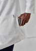 A white longline lab coat with a pocket, featuring a hand holding a smartphone placed inside.