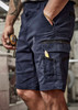 Navy work shorts featuring multiple pockets and a small tool. Close-up of model holding a measuring tape.