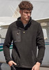 A man wearing a black unisex polar fleece with a quarter-zip and front pockets, set against an aircraft backdrop.
