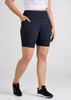 A pair of women's navy bike shorts with side pockets and a high waistband, displayed on a model.