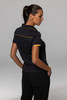 A black polo shirt with contrasting yellow accents, featuring a collar and logo.