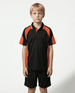 A child wearing a black polo shirt with orange accents, paired with black shorts, standing against a plain background.