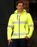 A bright yellow softshell hooded jacket featuring reflective 3M tape, with zippered pockets and a branding logo.