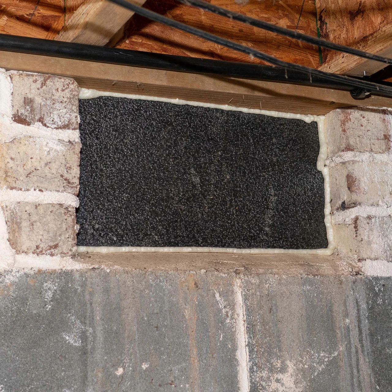 VentBlock installed over a foundation vent opening inside a crawl space