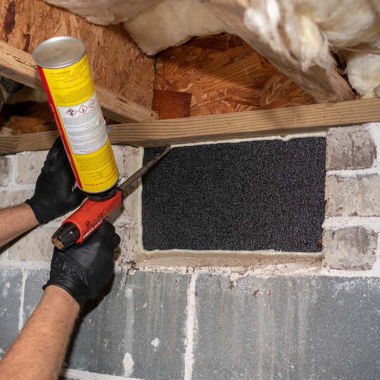 Sealing the edges of an installed VentBlock+ foundation vent blocker with spray foam