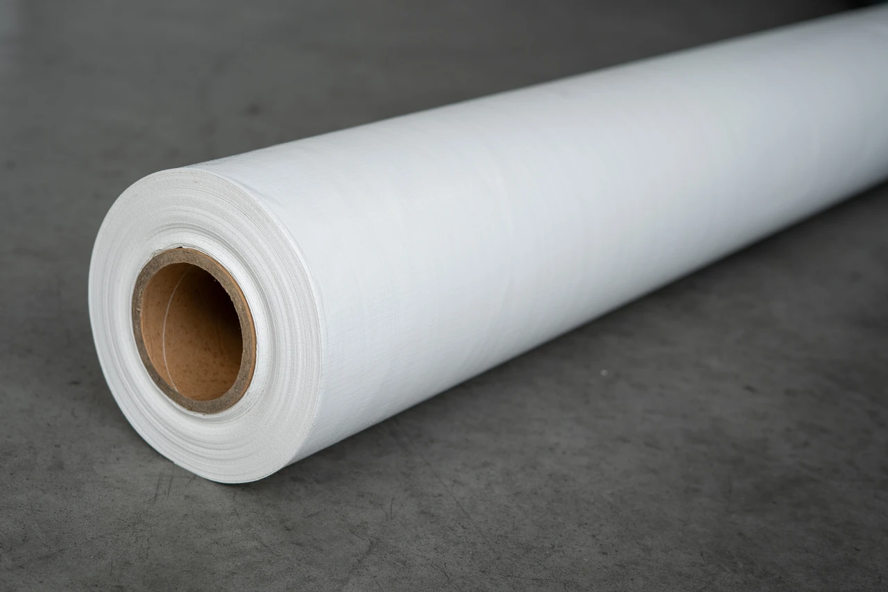 A complete roll of vapor barrier plastic that is woven coated polyethene