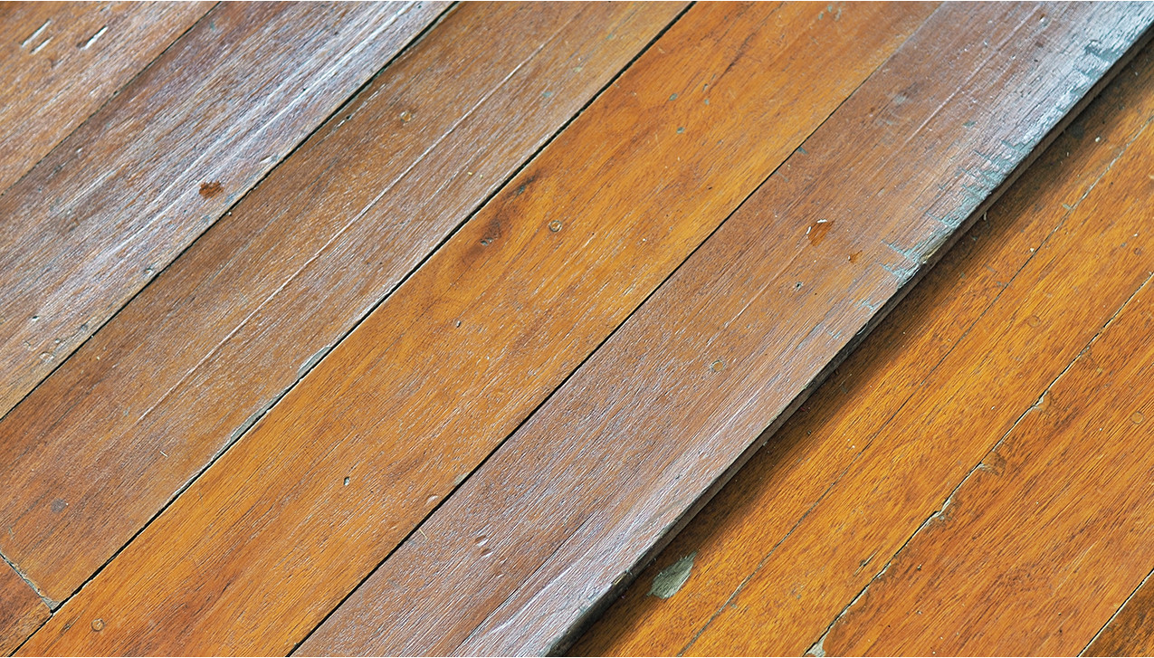 Why do my wood floors buckle and cup in the summertime?