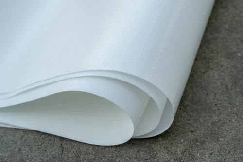 Close up of 14 mil woven coated crawl space vapor barrier