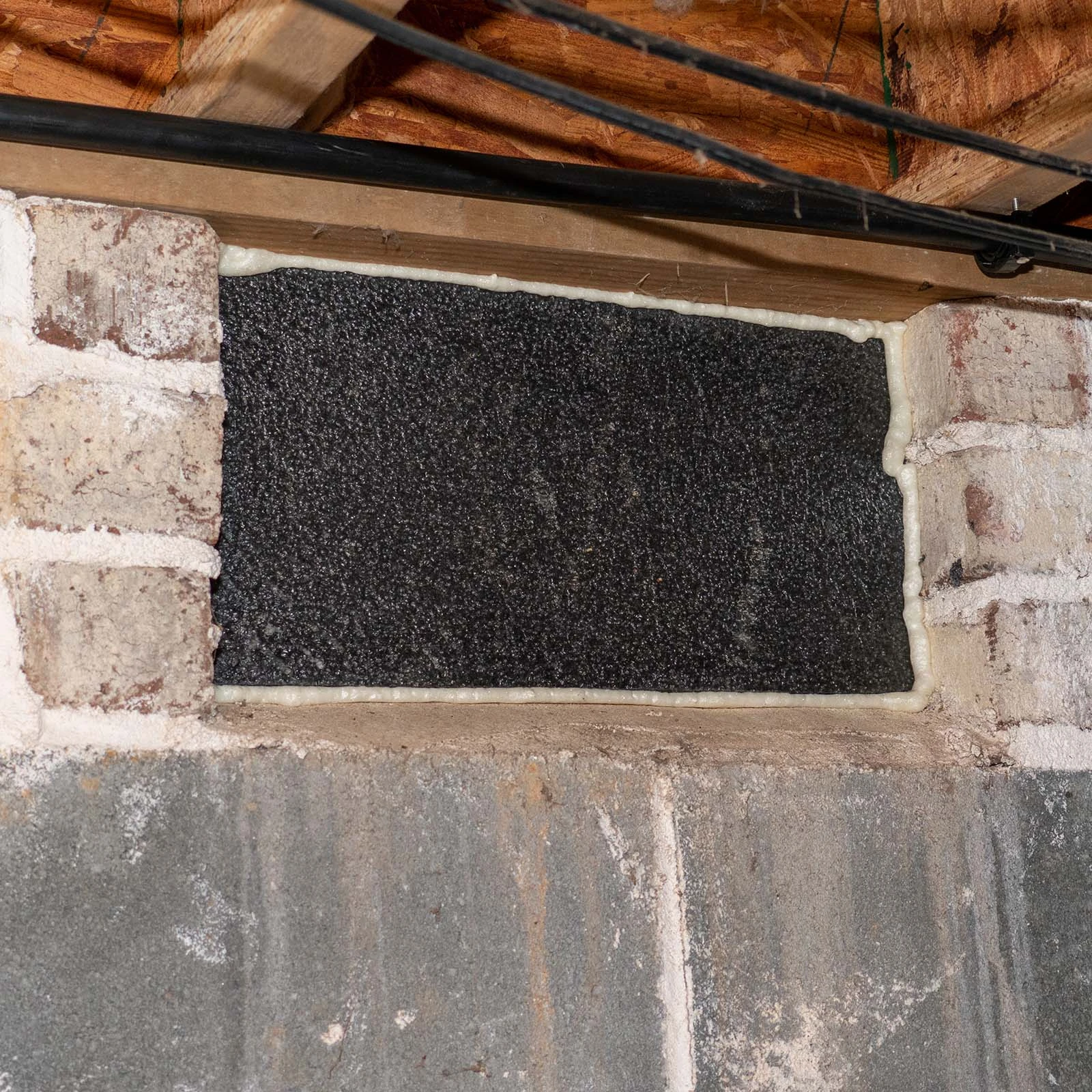 VentBlock+ completed installation over a foundation vent opening inside a crawl space