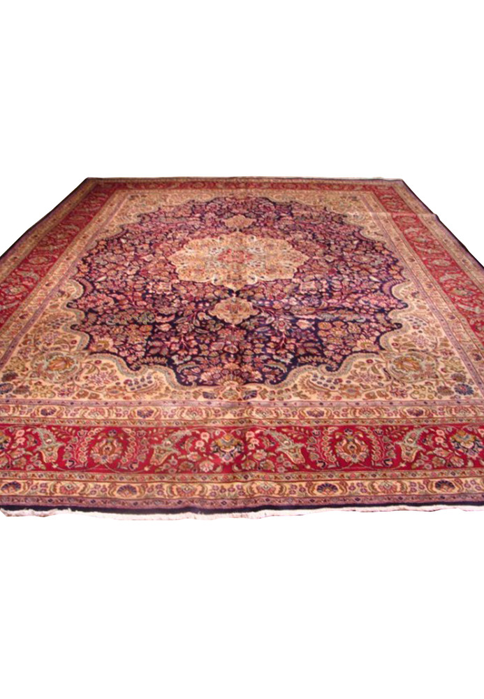 Full view of an 11'3" x 14'5" Persian Mashad rug with a navy field and vibrant floral patterns in red, beige, and pastel hues