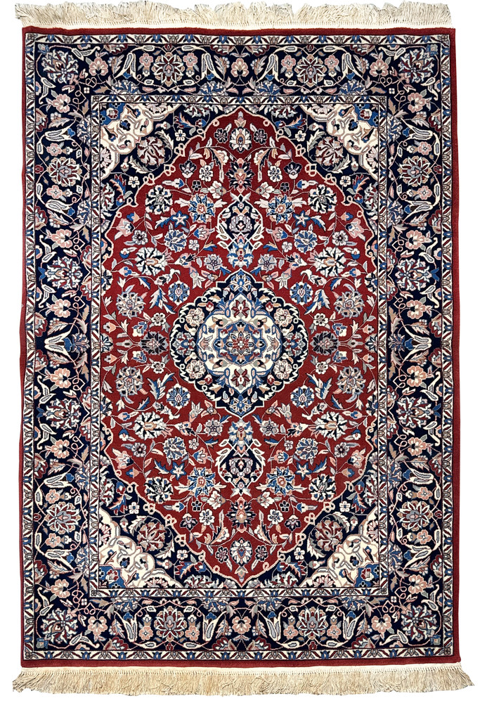 Full view of handmade Persian Isfahan wool and silk rug with traditional design and fringed edge Full view of handmade Persian Isfahan wool and silk rug with traditional design and fringed edge